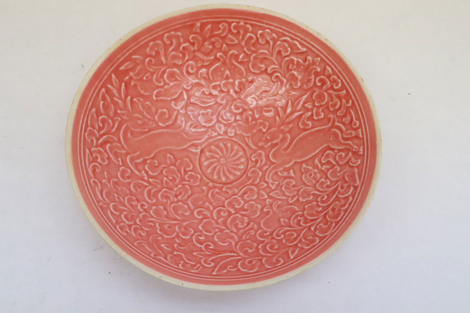 Pink glazed porcelain bowl: Pink glazed porcelain bowl with embossed decoration, 2.5"x7.85"dia