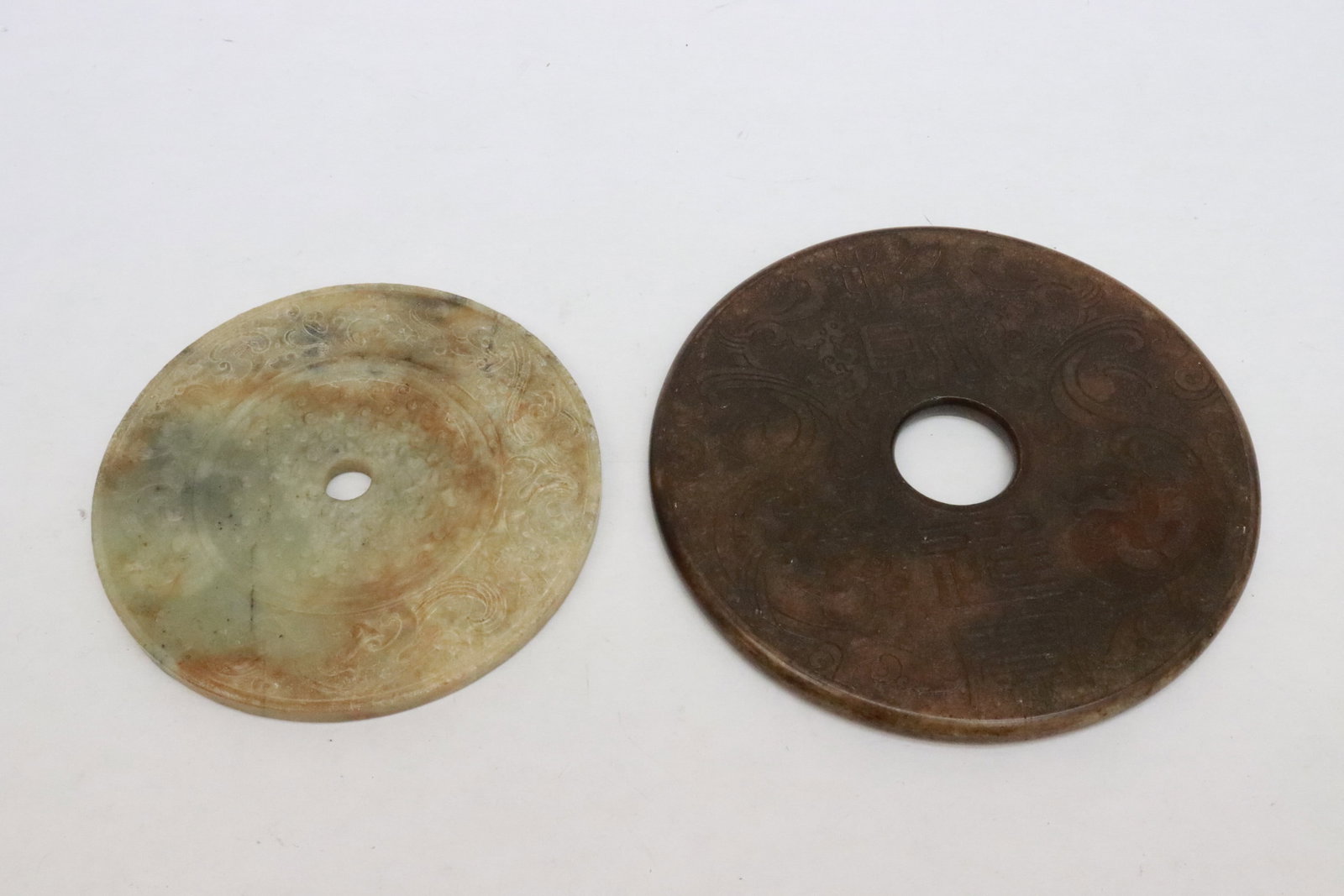 2 large jade like stone discs: 2 large jade like stone discs, 0.3"x4.7"dia, 0.33"x5.7"dia