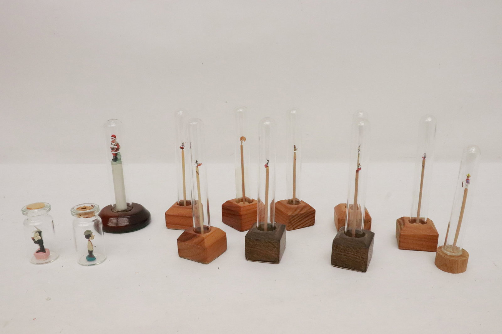 12 miniature ornaments in glass tube: 12 miniature ornaments in glass tube, 1.63"x0.83"dia - 3.9"x1.1"x1.1"