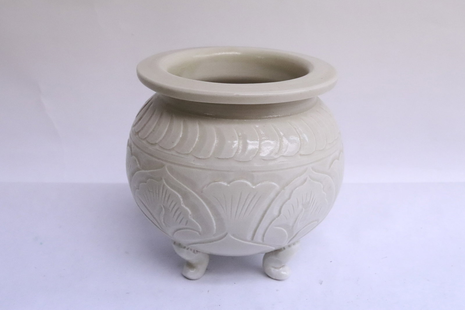 A white porcelain tripod censer: A white porcelain tripod censer incised with floral motif decoration, 4.7"x4.9"dia