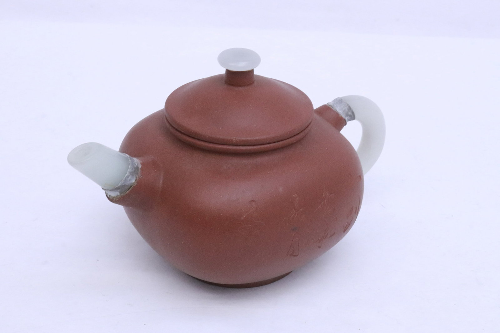 Yixing teapot with jade like handle and spout: Yixing teapot with jade like handle and spout, 3.8"x6.3"x4"