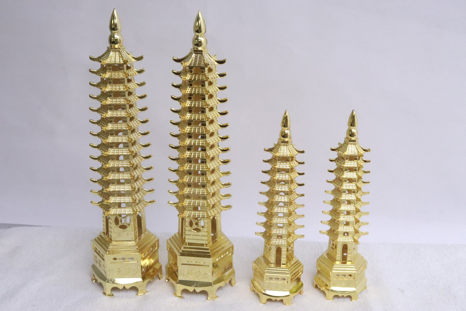 4 gold tone pagodas: 4 gold tone pagodas, 7"H - 10.18"H