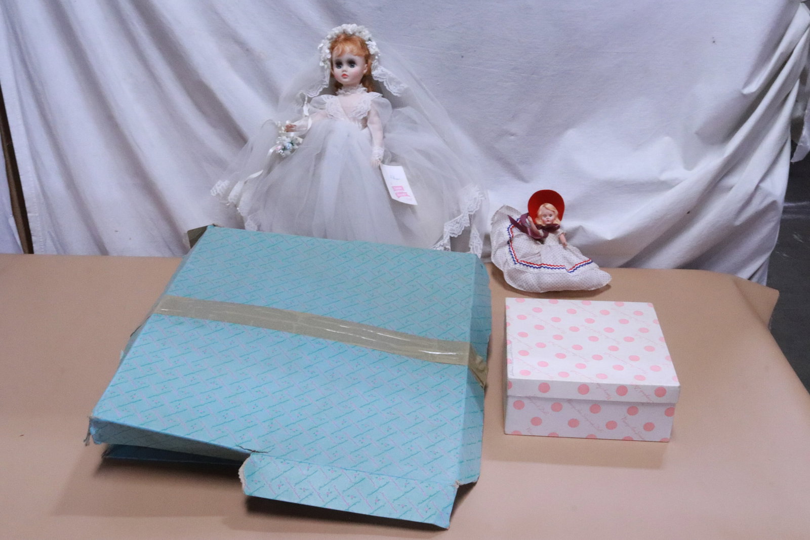 2 dolls in new condition in original box: 2 dolls; Elise of Madame Alexander (6.7"H (3.65"x8.7"x8.7")), and a Nancy Ann storybook doll (17.2"H (5"x17.4"x18.8")), both in new condition in original box