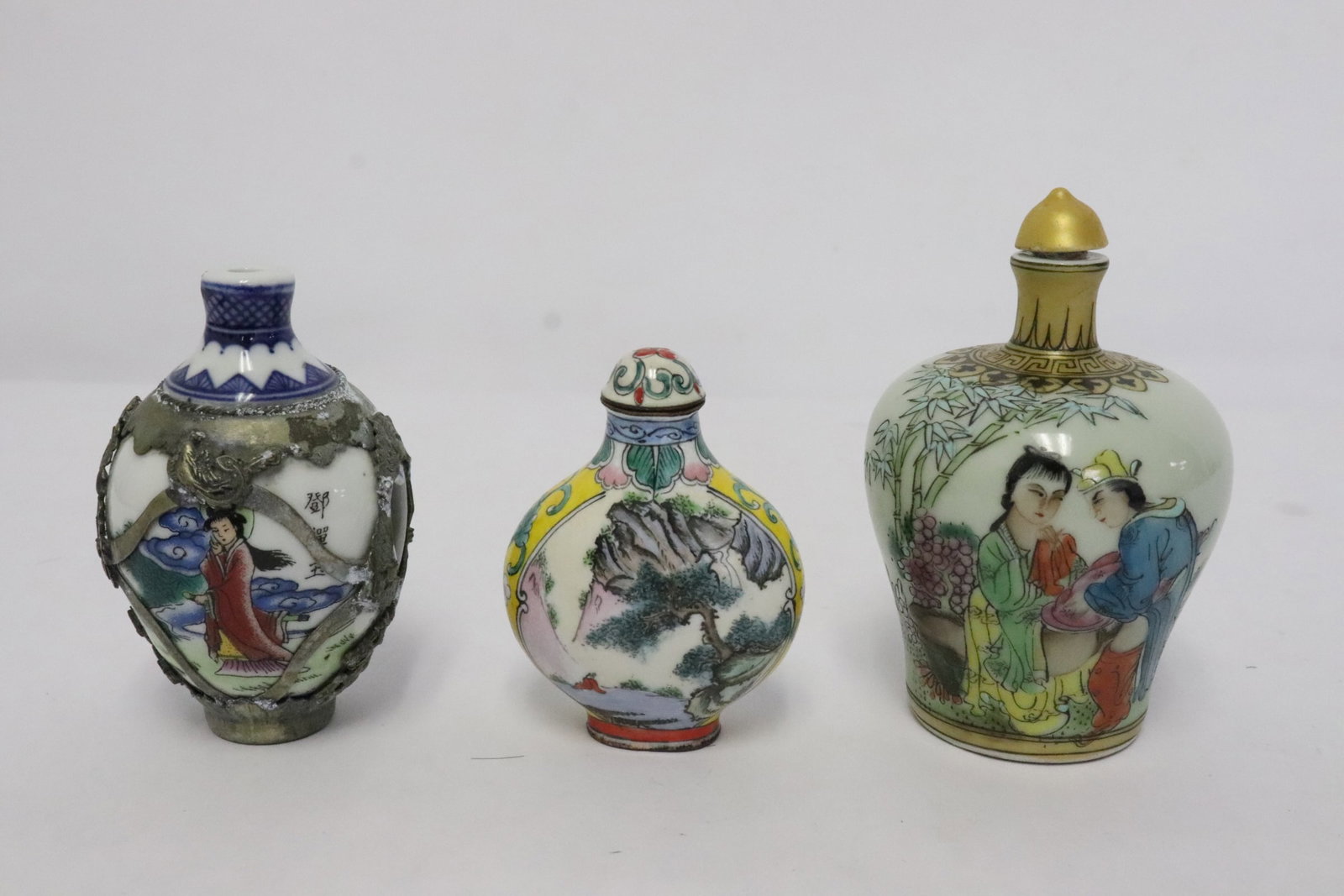 3 snuff bottles; 2 porcelain, one enamel on metal: 3 snuff bottles (2.5"x1.8"x1" - 3.4"x2.25"dia); 2 porcelain, one enamel on metal