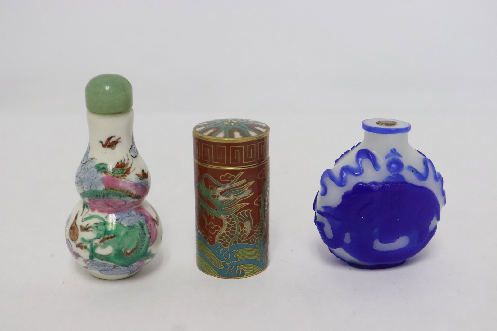 3 Chinese snuff bottles: 3 Chinese snuff bottles (2.1"x1.85"x0.9" - 2.85"x1.3"dia); cloisonne, Peking glass, and porcelain