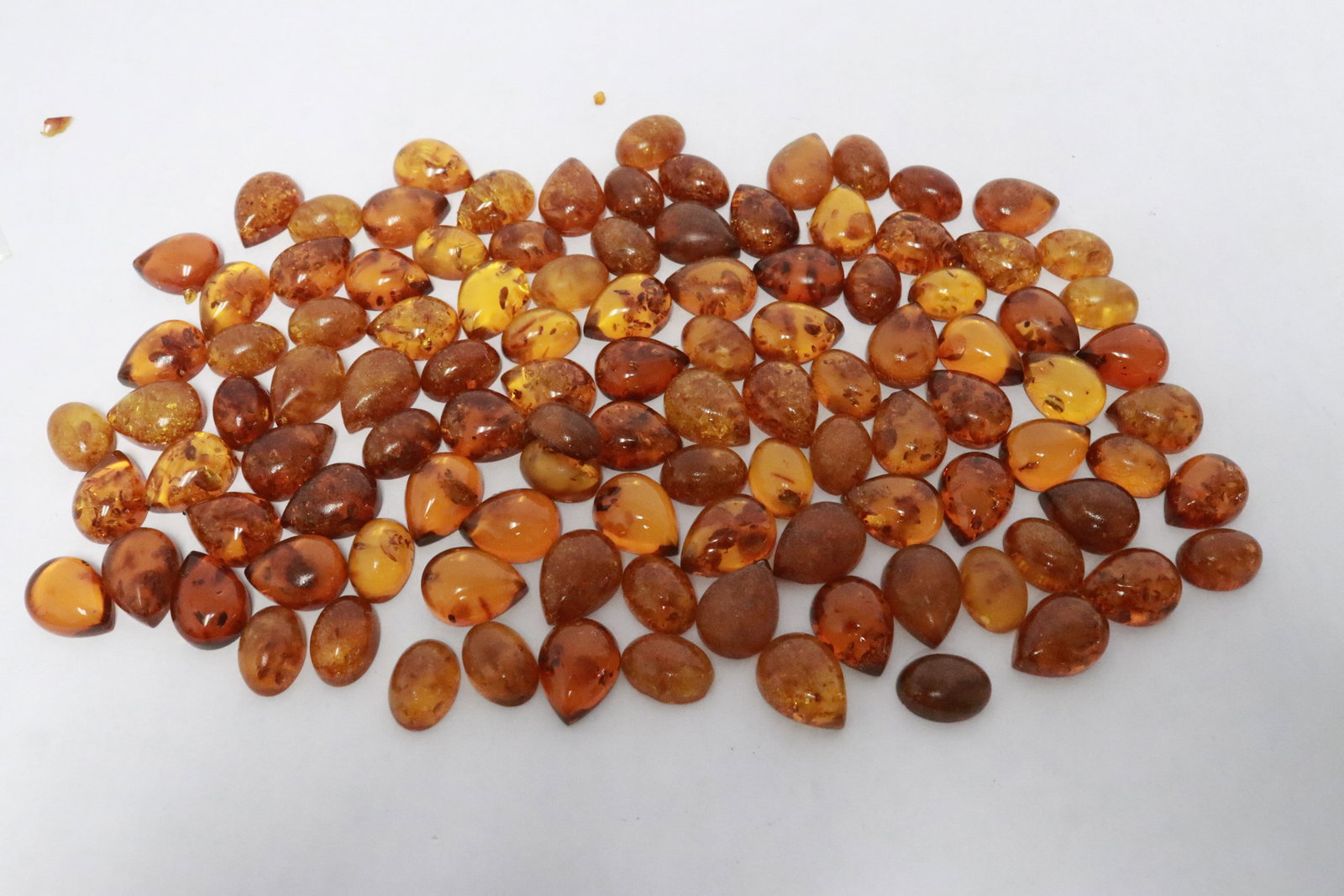 Large lot of amber like cabochon: Large lot of amber like cabochon, 0.6"x0.35"x0.25" - 0.65"x0.45"x0.25"