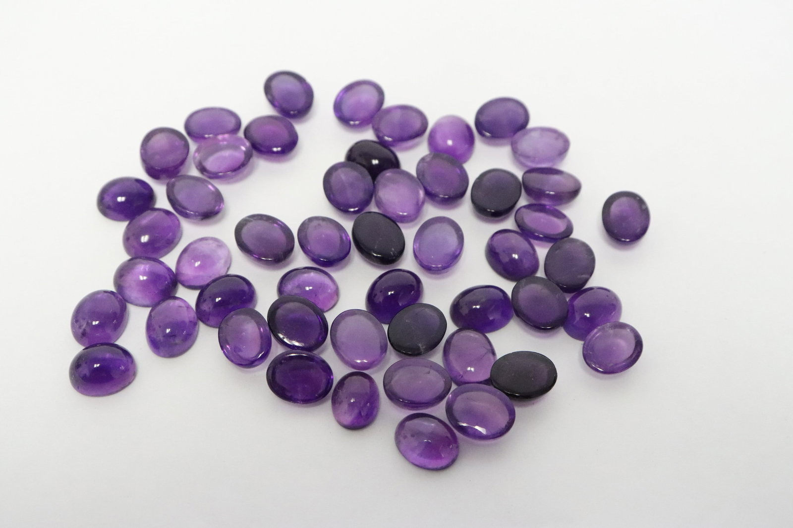 Lot of polished amethyst cabochon stones: Lot of polished amethyst cabochon stones, wt. approx. 145ct