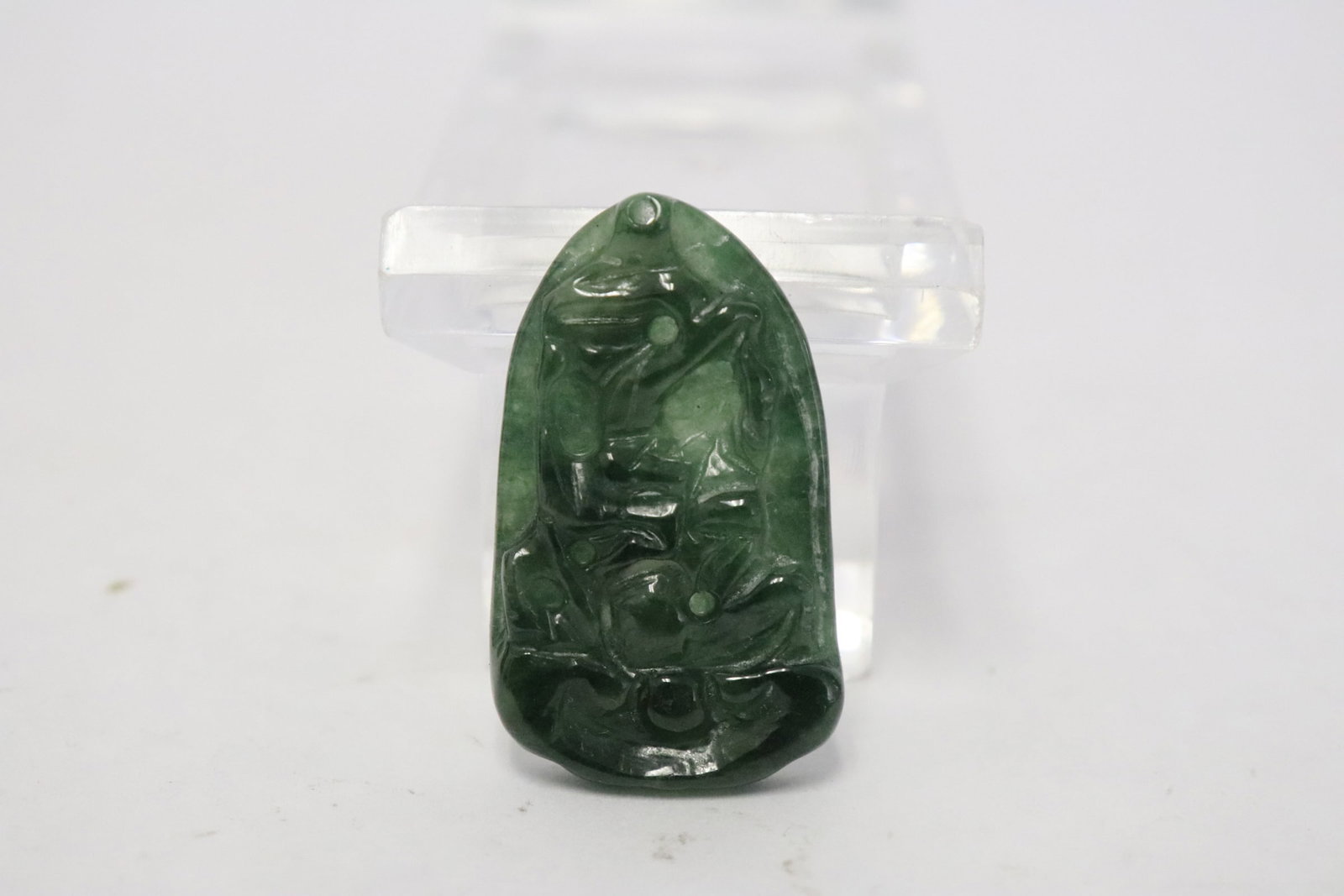 Chinese translucent emerald green jadeite: A beautiful Chinese translucent emerald green jadeite carved pendant with decoration in relief, 1.5"x0.85"x0.18" (box:2.6"x2.1"x1.15")