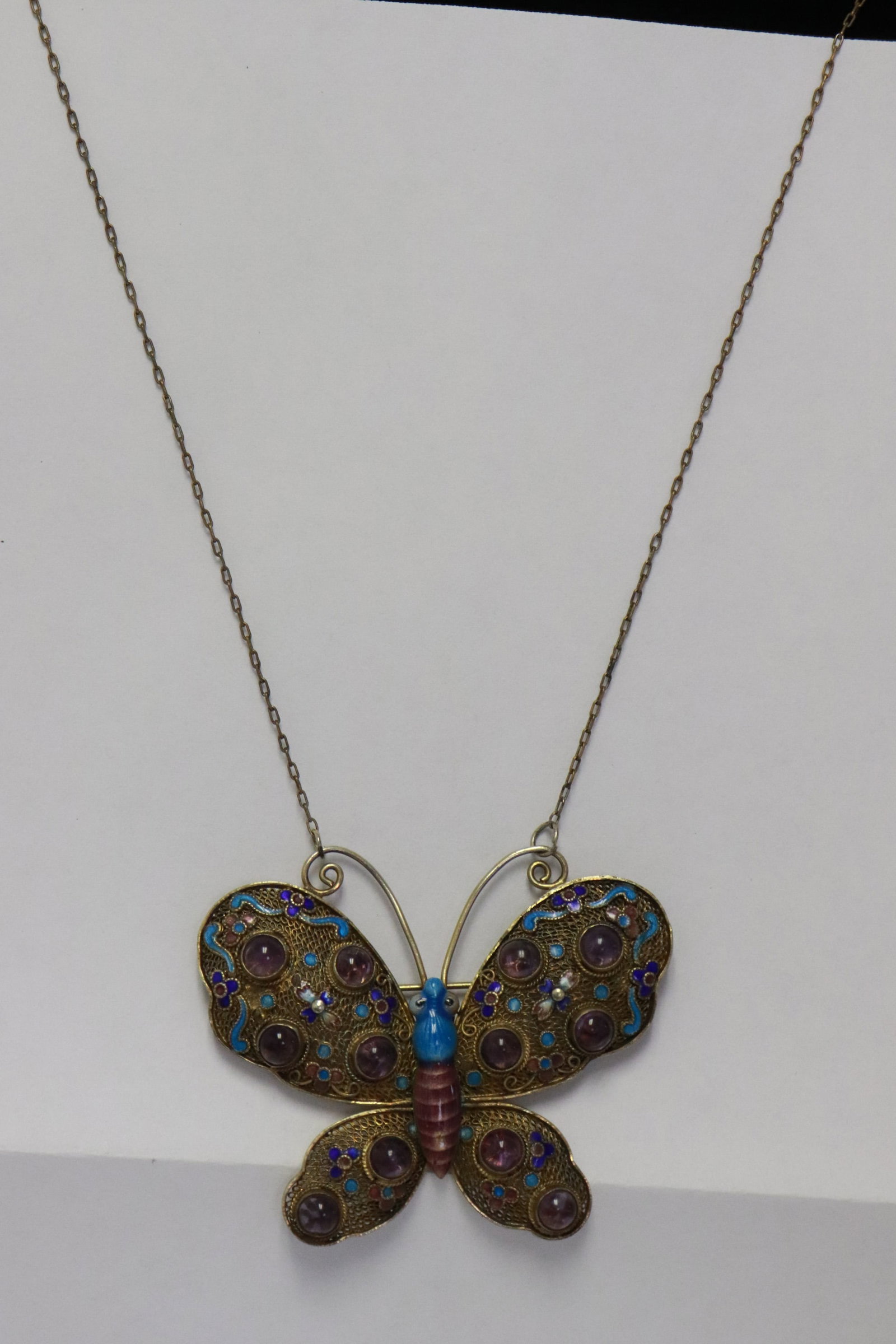 19th c. enamel silver pendant w/ amethyst & necklace: Beautiful Chinese 19th century enamel silver butterfly motif pendant (1.8"x1.2"x0.35") with amethyst cabochon attached to a necklace, wt. 14gm (box:3.18"x2.35"x1.7")