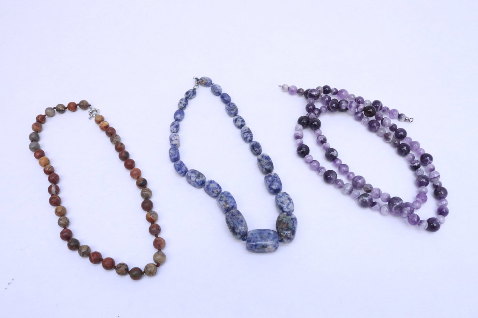 3 necklaces: 3 necklaces (19"L - 35"L); an amethyst bead necklace (need clasp), a Picasso jasper stone bead necklace, and a blue spot jasper stone bead necklace
