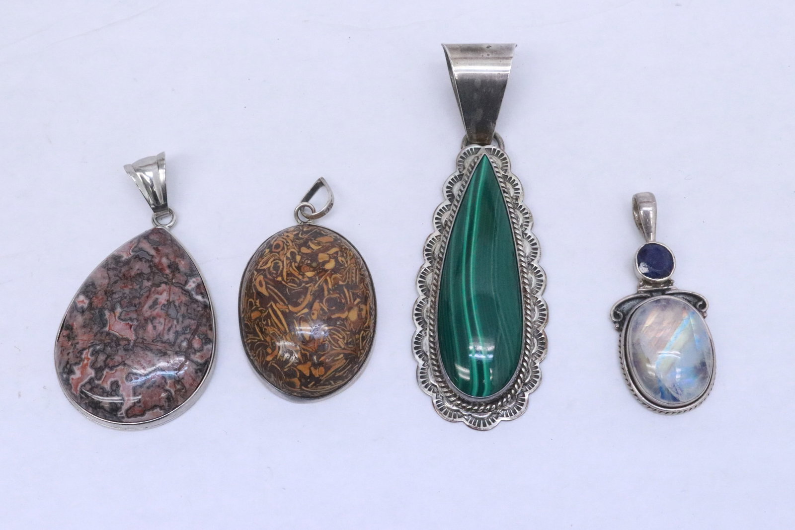 4 sterling pendants with semiprecious stones: 4 sterling pendants with semiprecious stones, wt. 68.5gm, 1.75"x0.75"x0.33" - 3.2"x1.1"x0.33"