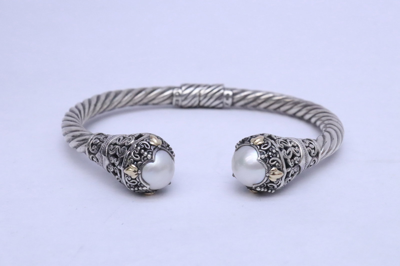 sterling bangle w/ 18K accent & cultured pearls, signed: A beautiful sterling bangle with 18K accent, with 2 fine cultured pearls, measures approx. 11mm diameter each, signed by artist, wt. 28gm, 0.6"x3"x2.8"