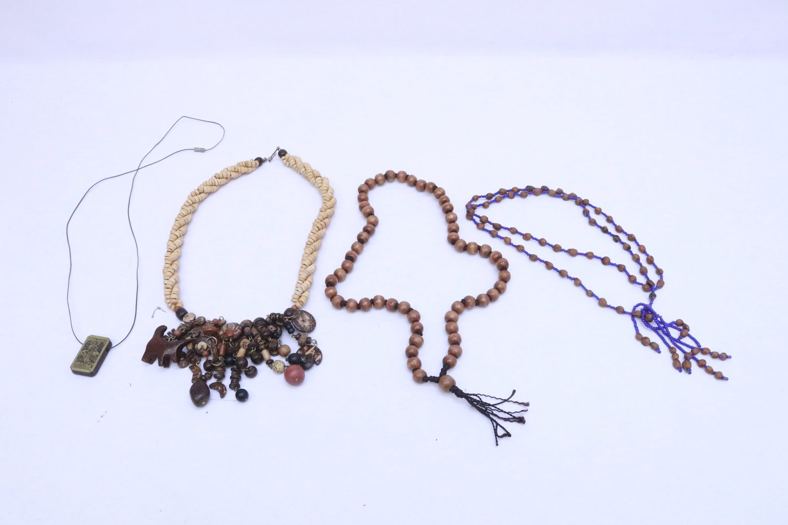 3 wood bead necklaces, and a wood pendant: 3 wood bead necklaces (21"L - 32"L), and a wood pendant