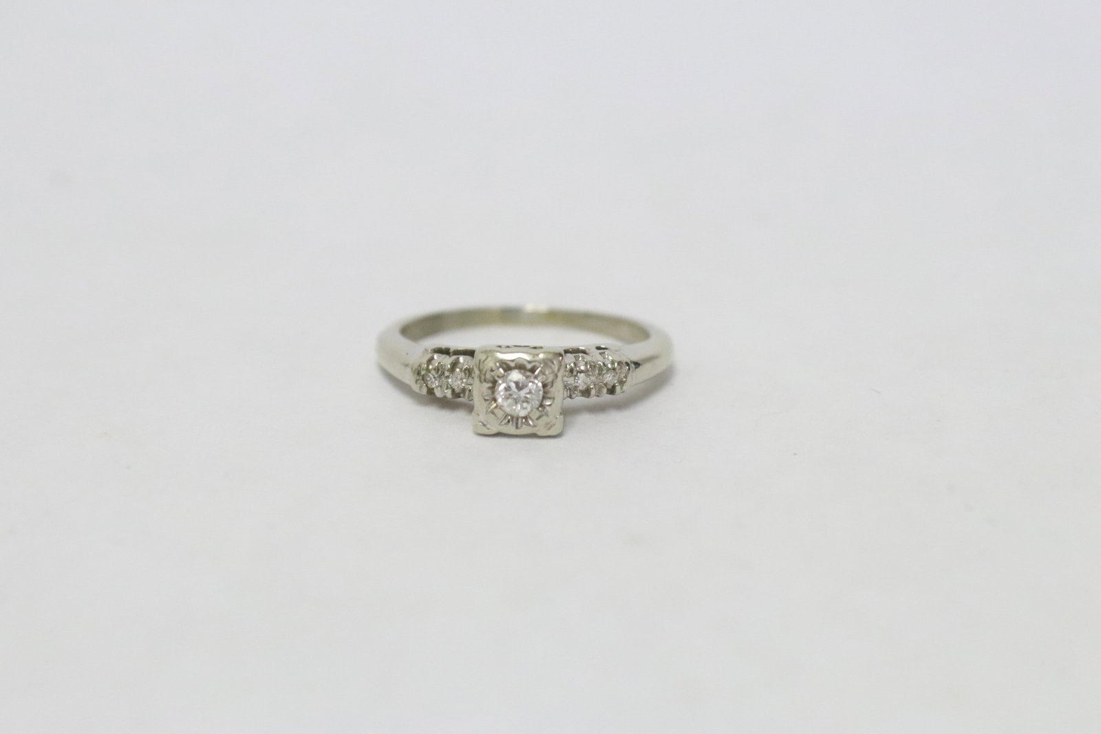 14K W/G diamond ring: 14K W/G diamond ring, center a brilliant cut diamond wt. approx. 0.10ct, wt. 2.8gm, size 6