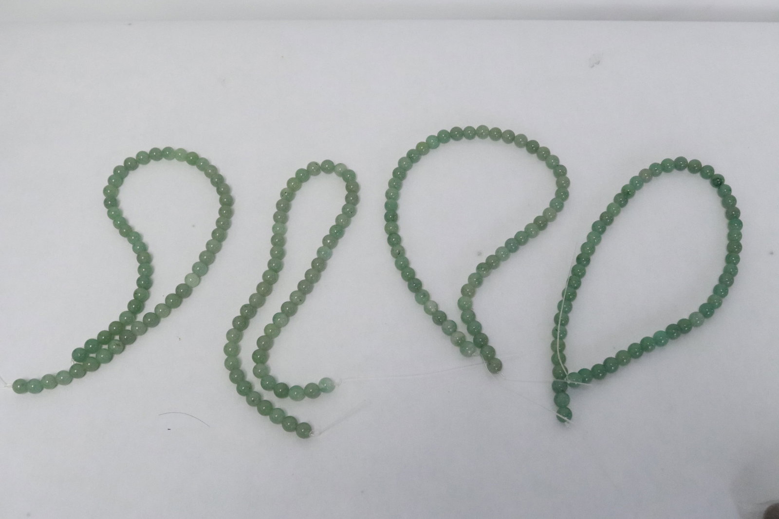 4 jadeite like bead necklaces: 4 jadeite like bead (0.33"x0.33"dia ea) necklaces (15.8"L ea), need clasp
