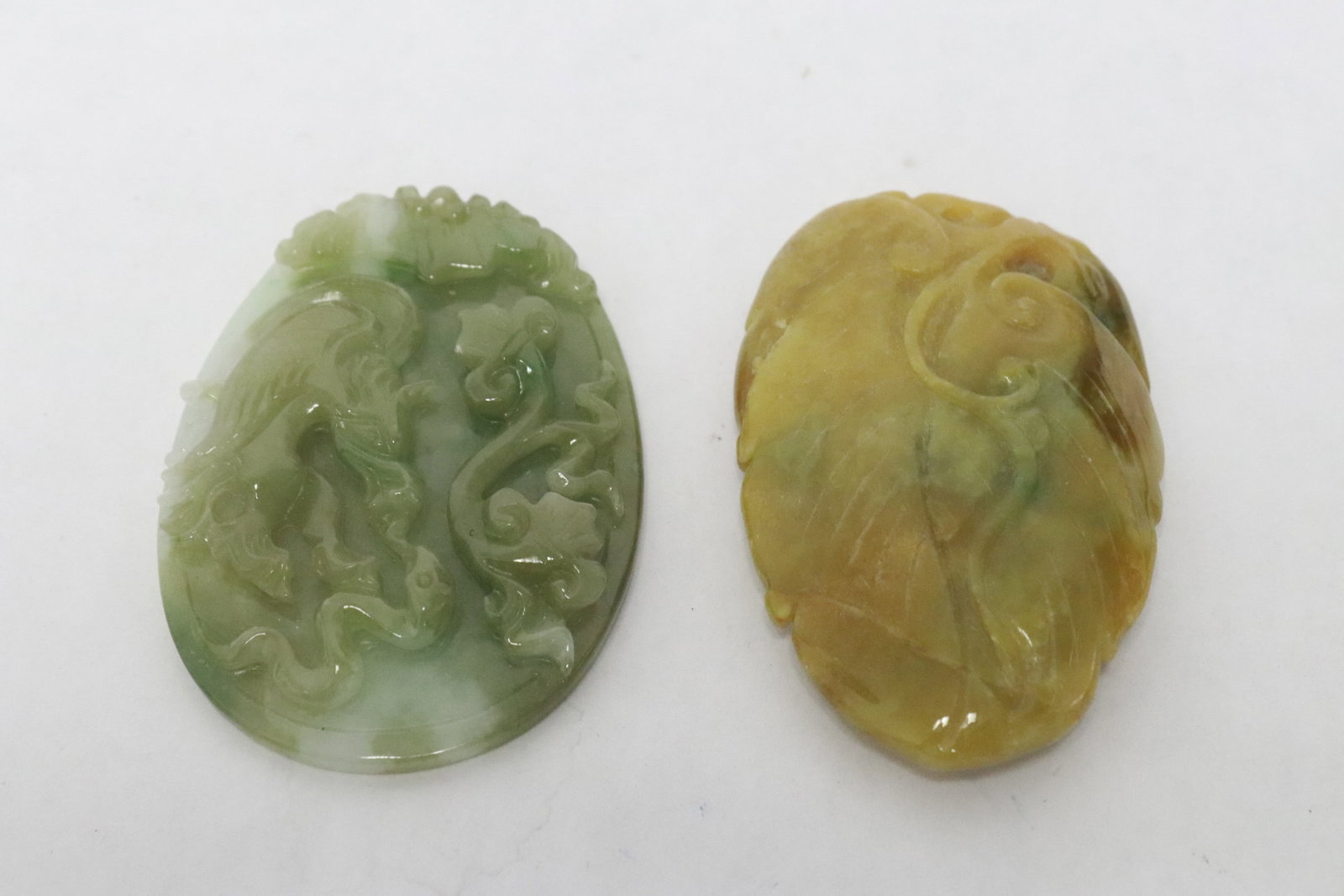 2 very fine jadeite carved pendant: 2 very fine jadeite carved pendant with decoration in relief, 2.4"x1.63"x0.5", 2.4"x1.75"x0.3"