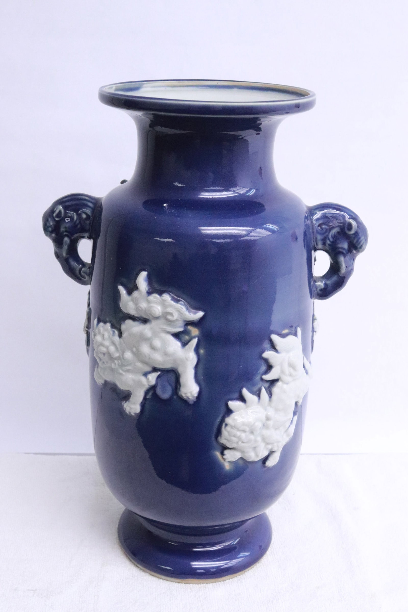 early 19th century white on blue porcelain vase: An important early 19th century white on blue porcelain vase with decoration in relief, 14.4"x9.35"x7.2"
