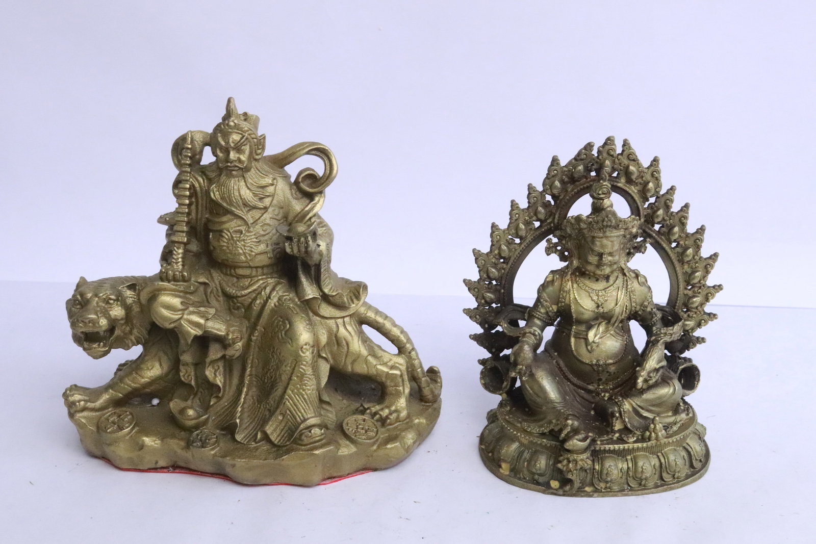 2 brass sculptures of deity: 2 brass sculptures of deity, 4.65"H, 5.1"H