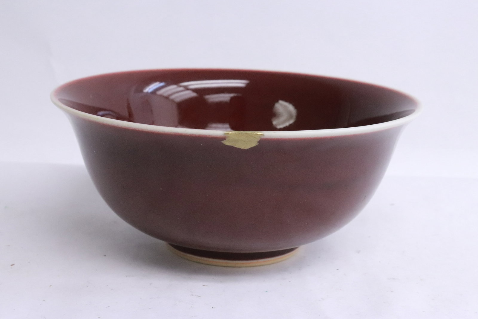 A red glazed porcelain bowl, edge chip: A red glazed porcelain bowl, edge chip, 2.8"x6.35"dia
