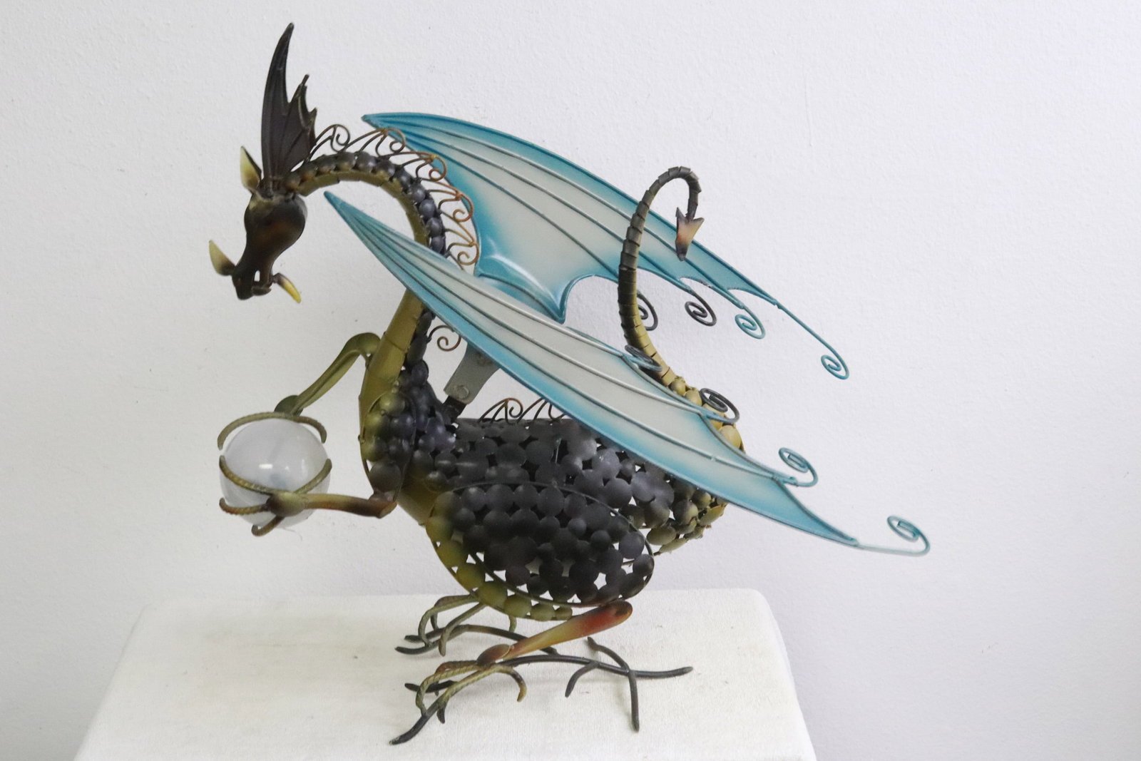 A painted metal garden ornament: A painted metal garden ornament in winged dragon motif, 22.5"H
