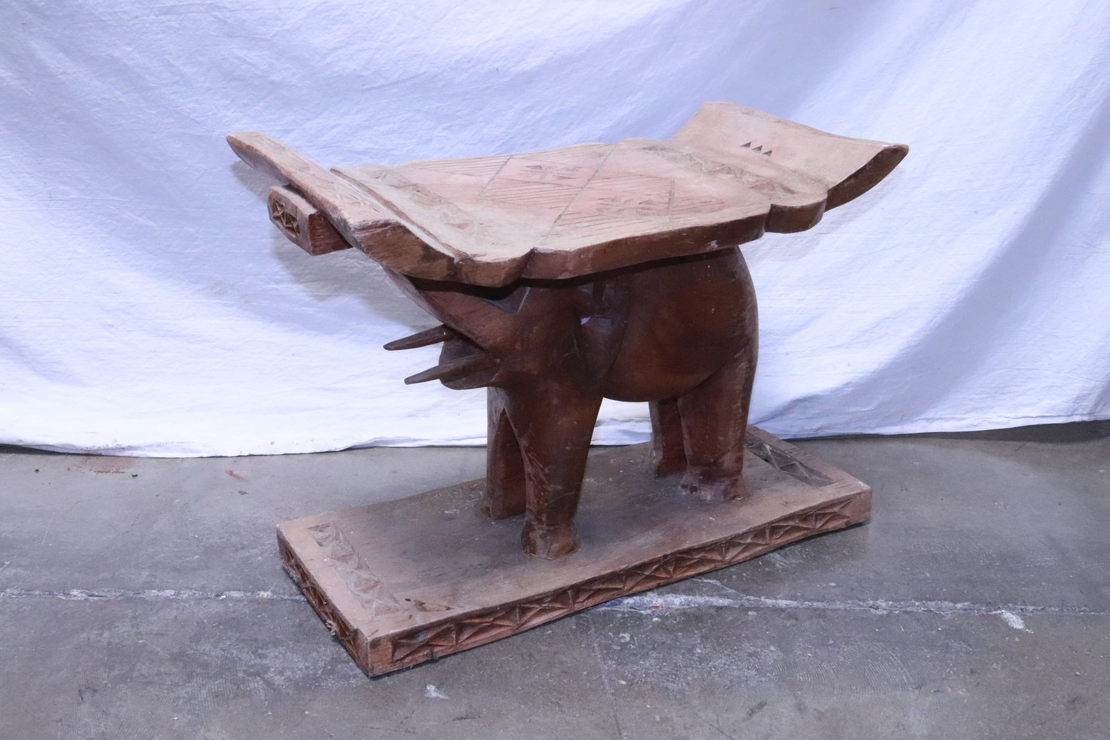 Wood carved stool with base in elephant motif: Wood carved stool with base in elephant motif, 15"x22"x10.3"