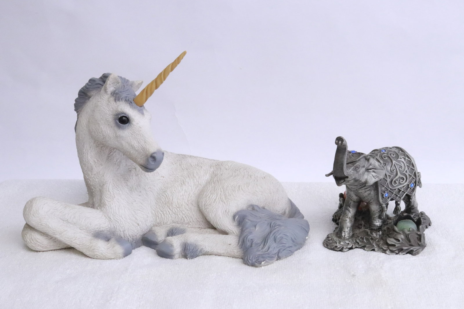 A pewter elephant, and a sculpture of unicorn: A pewter elephant (4.6"H), and a sculpture of unicorn (7.1"H)