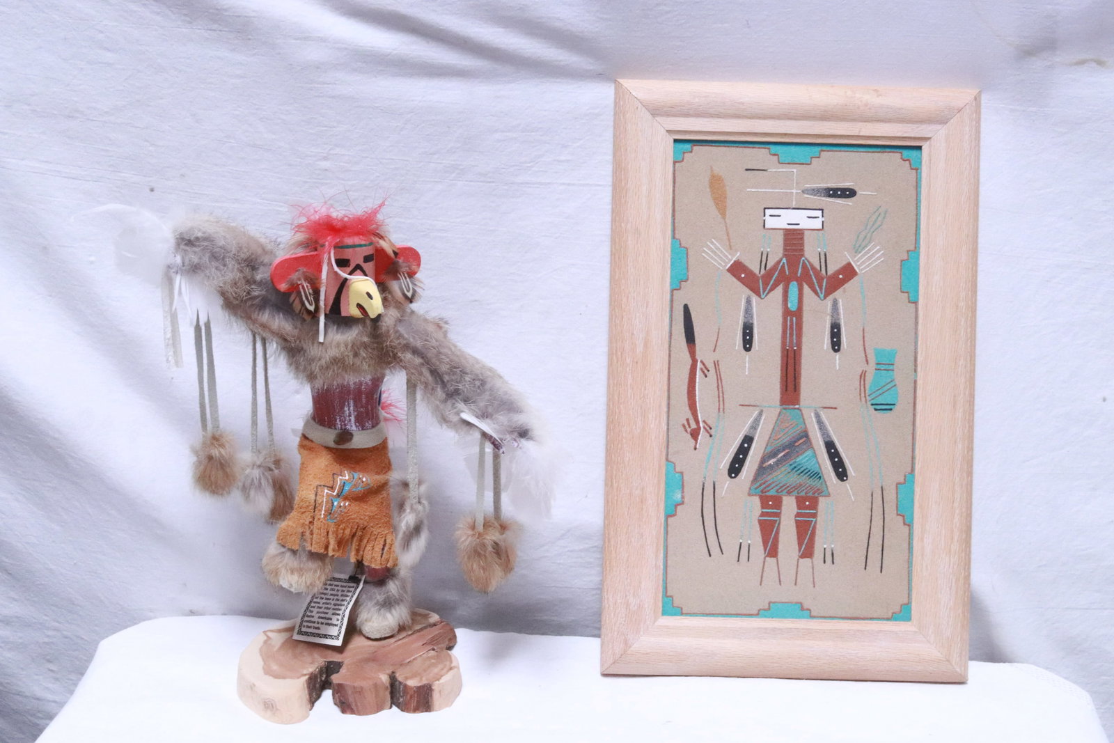 an Indian sand painting, and a Kachina doll: 2 pieces; an Indian sand painting (12.6"x6.5" (F:15.75"x9.8"x1")), and a Kachina doll (12.7"H)