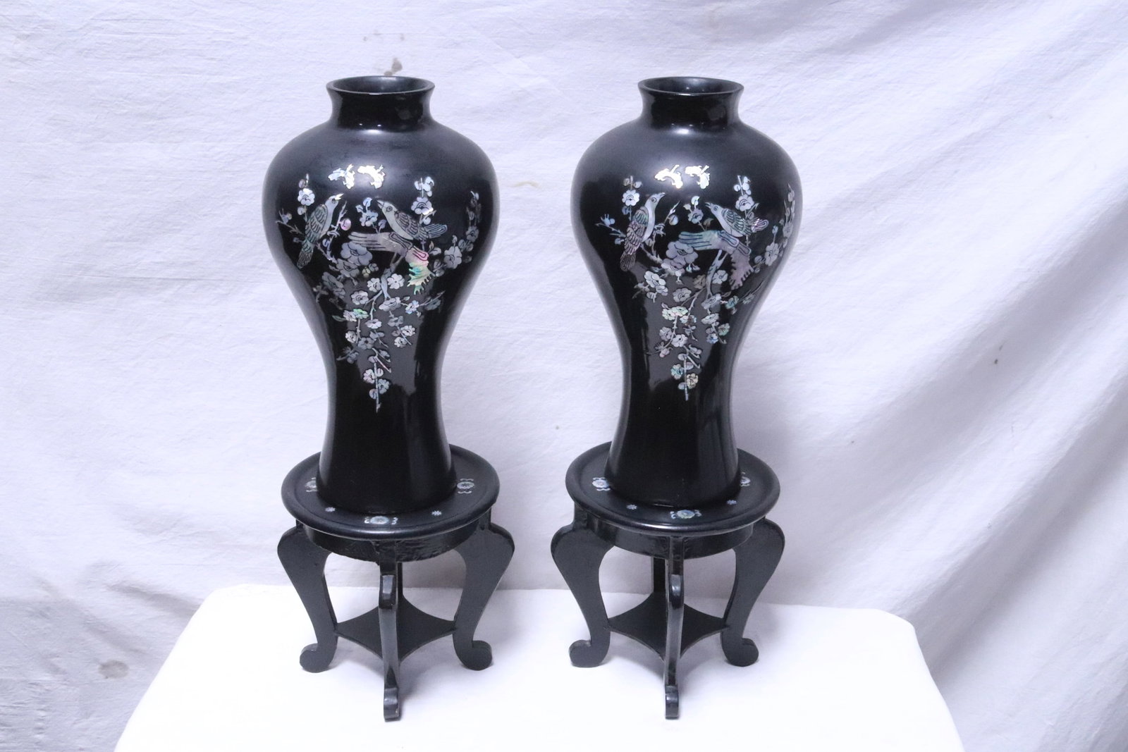 Pair black lacquer vases inlaid w/ MOP on stand: Pair black lacquer vases (13.1"x7.25"dia ea) on stand (7.33"x7.8"dia ea), with mother of pearl inlaid