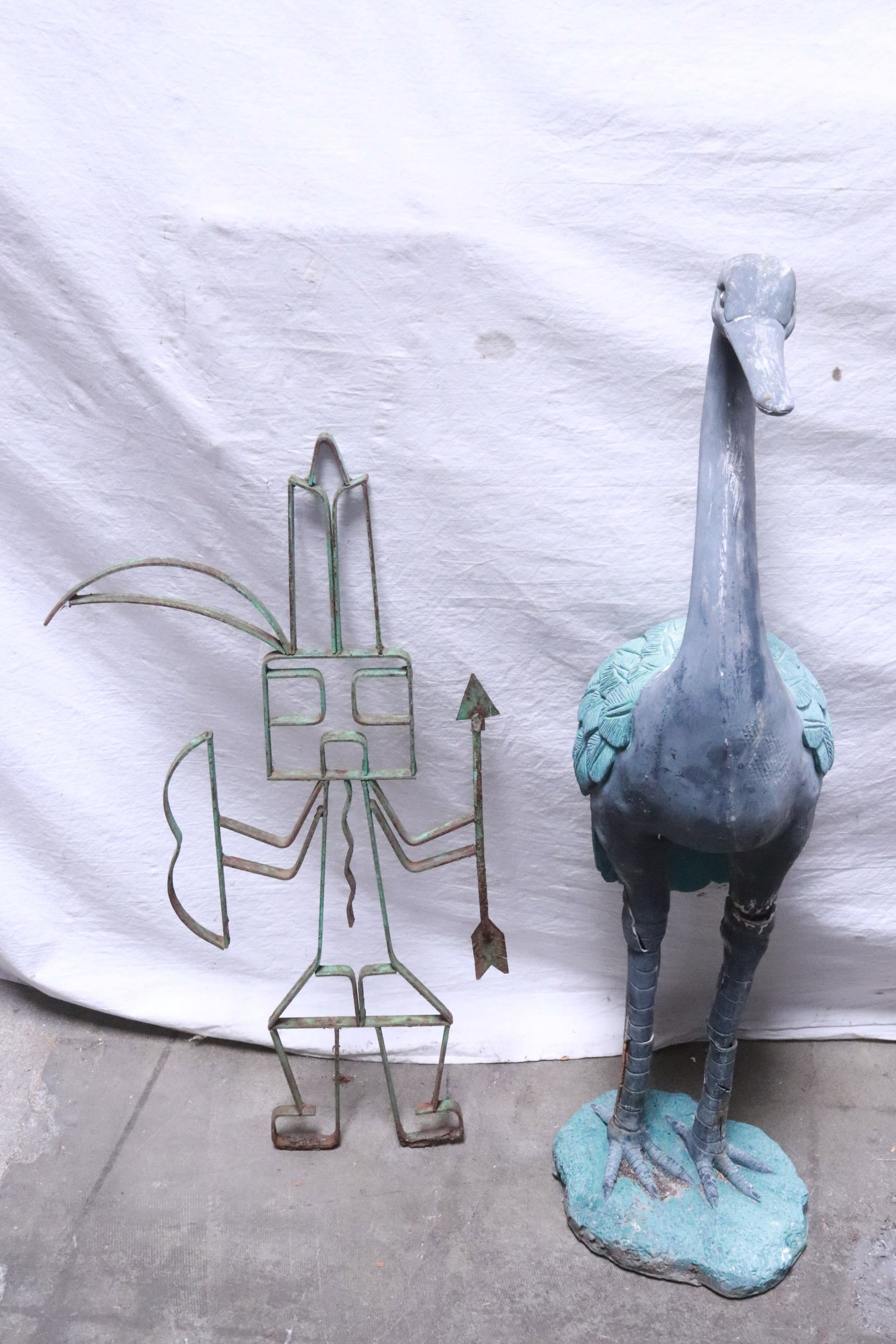 a metal figure, and a composition crane: 2 pieces garden ornament; a metal figure (25.8"H), and a composition crane (33.4"H), crane leg crack