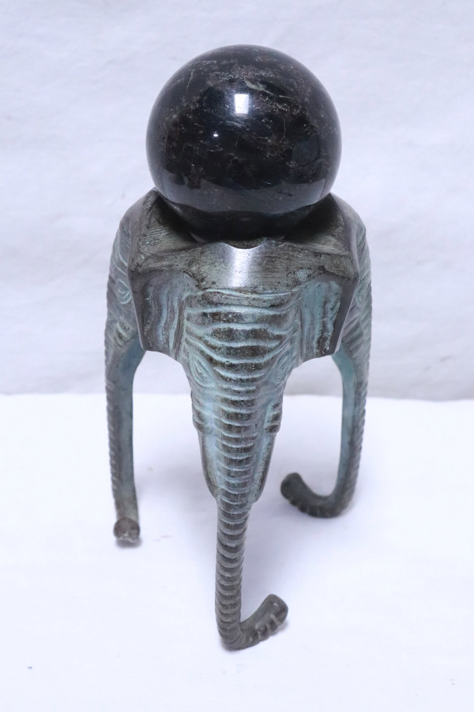 An astrophyllite sphere on elephant motif bronze stand: A rare astrophyllite sphere (2.6"x2.6"dia) on elephant motif bronze stand (5.9"x3.8"x3.8")