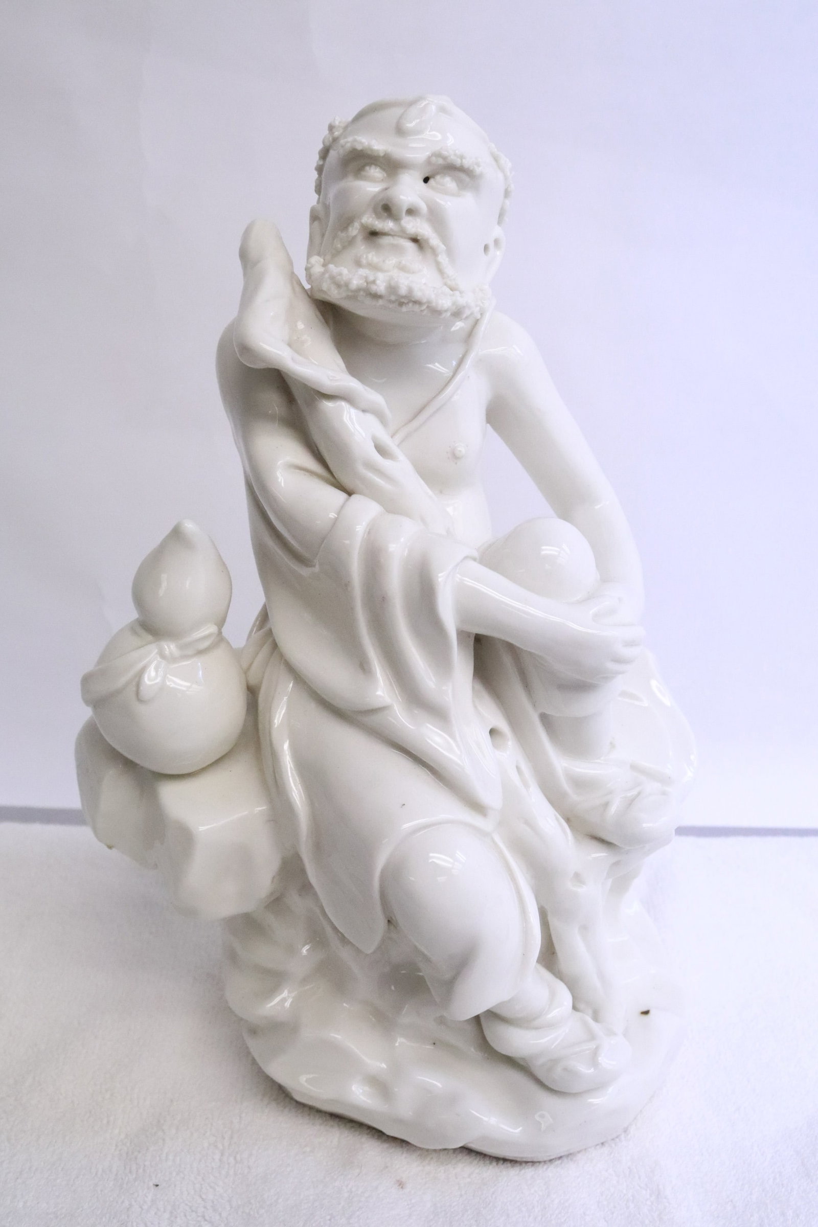 A blanc de shin porcelain deity: A blanc de shin porcelain deity, 9.8"H