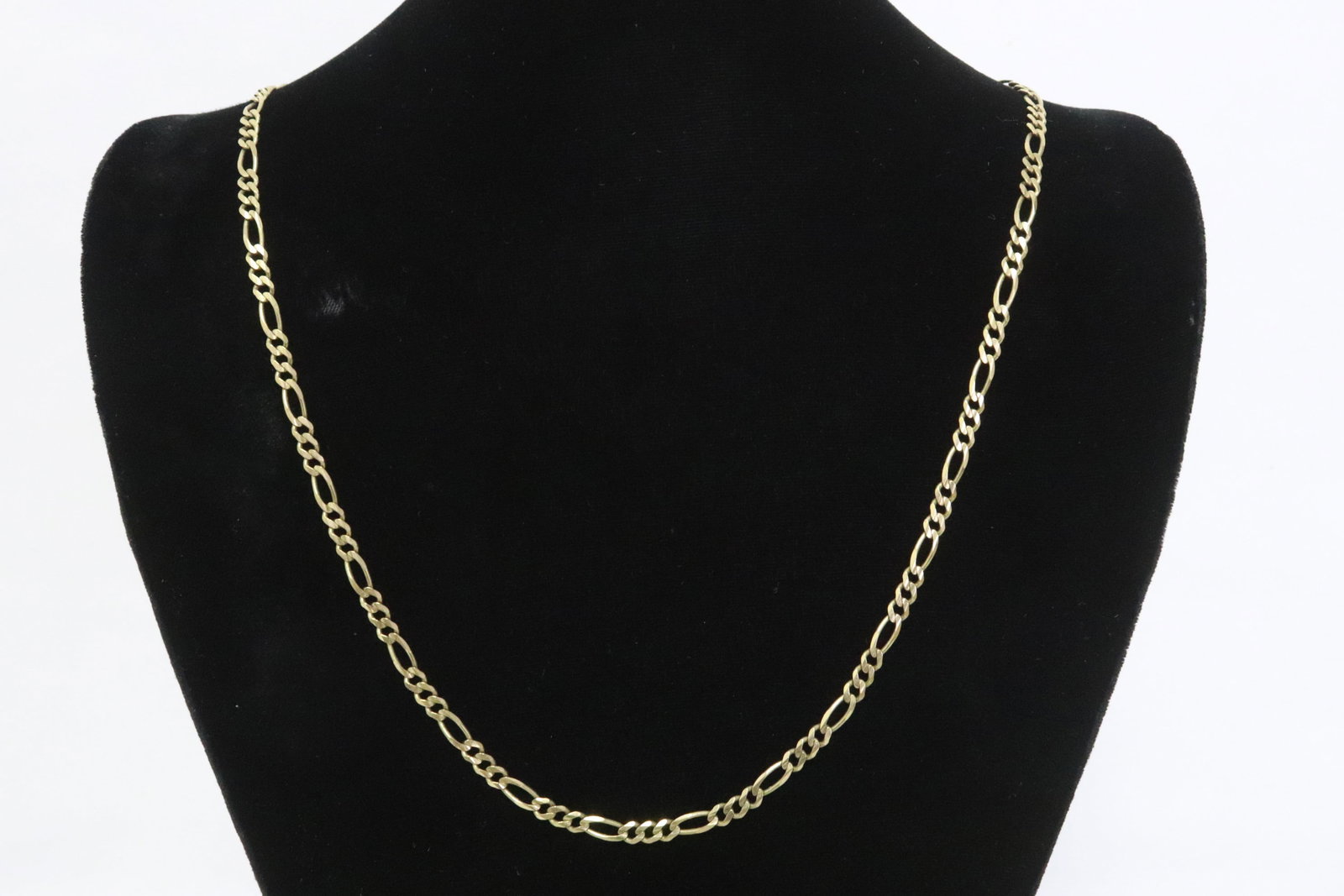 A 10K Y/G figaro link necklace: A 10K Y/G figaro link necklace (24.13"L), wt. 13.0gm