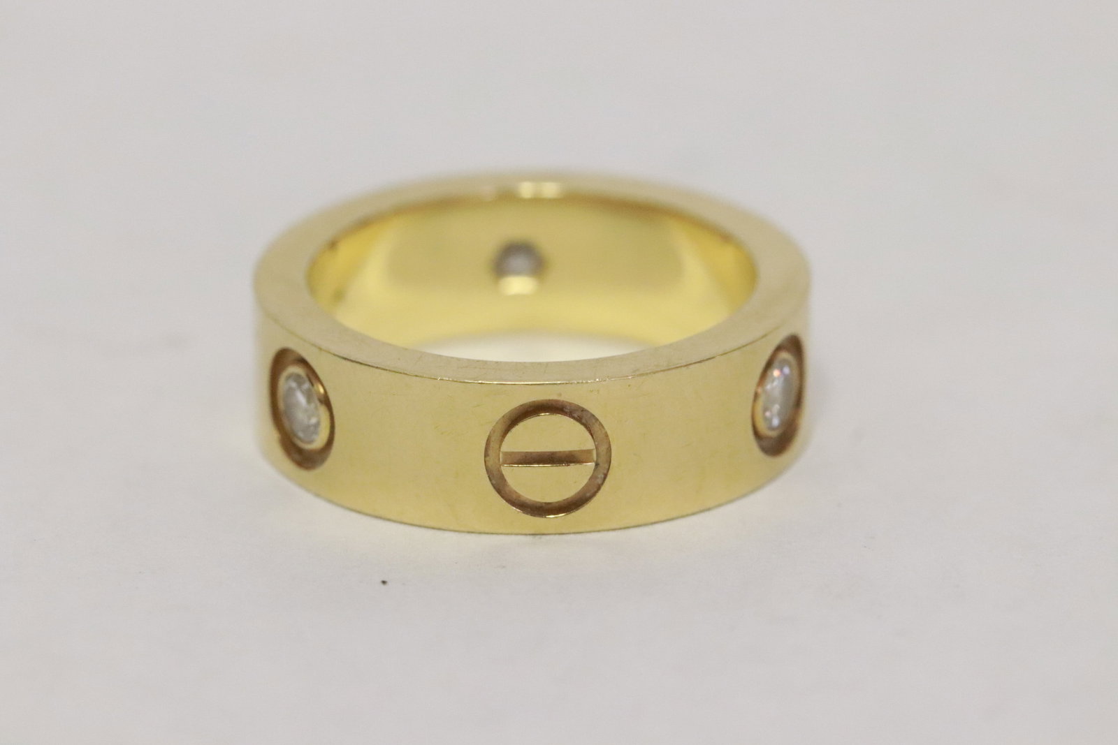 A Cartier 18K Y/G 3 diamond love ring: A Cartier 18K Y/G 3 diamond love ring, wt. 7.9gm, size 4.5, PX2578