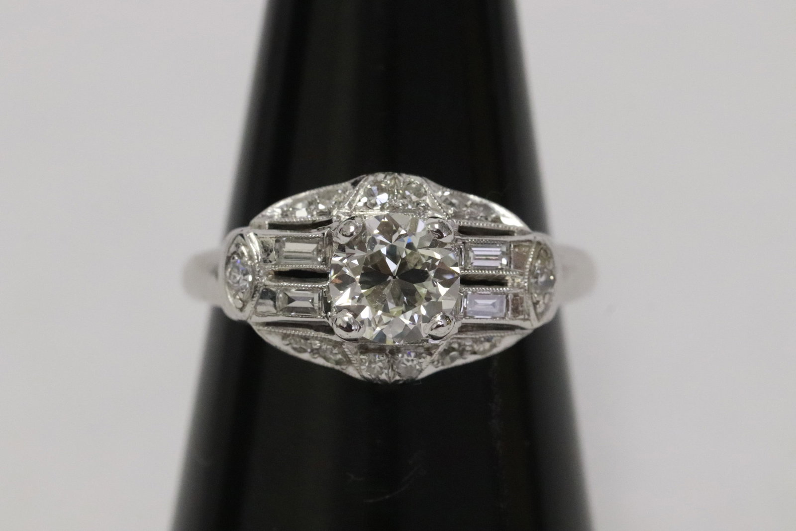 art deco platinum diamond ring: Beautiful art deco platinum diamond ring, center a gem quality diamond wt. approx. 0.80ct (measure 6.0x3.5mm) in VVS/VS, J quality, accented with 4 baguettes and small diamonds, tdw approx. 1.0ct,