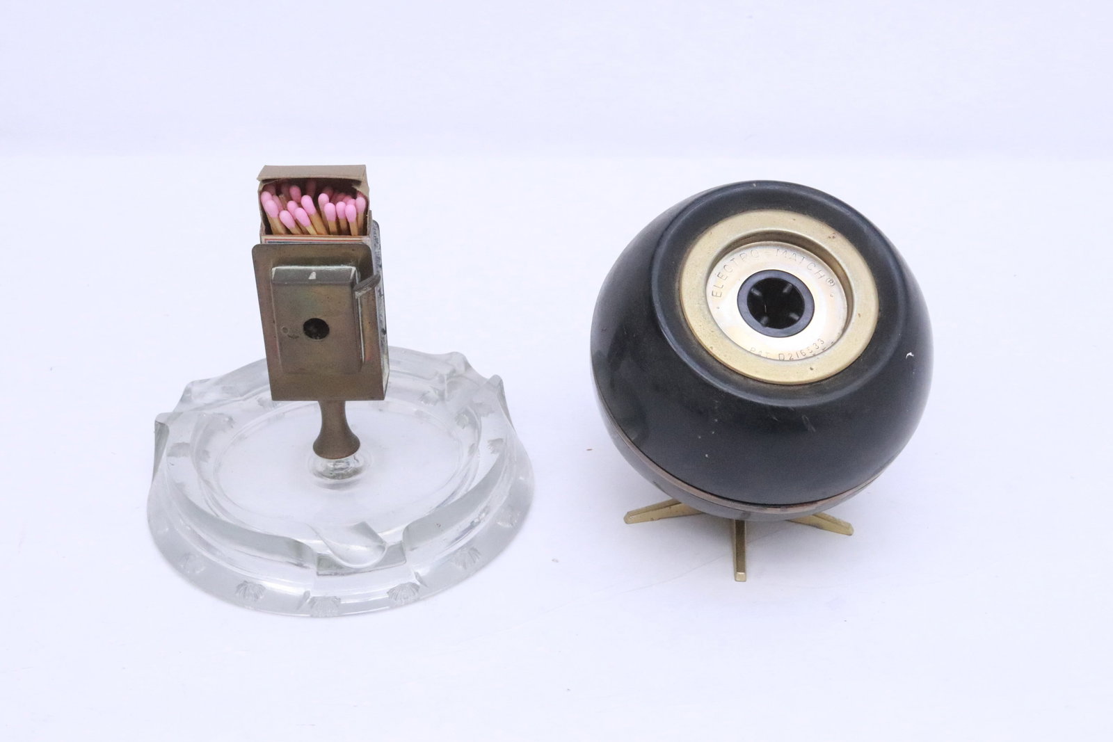 an electro match, and a table match server: 2 pieces; an electro match (5.1"x4.5"dia), and a table match server (4.35"x5.65"dia), condition unknown