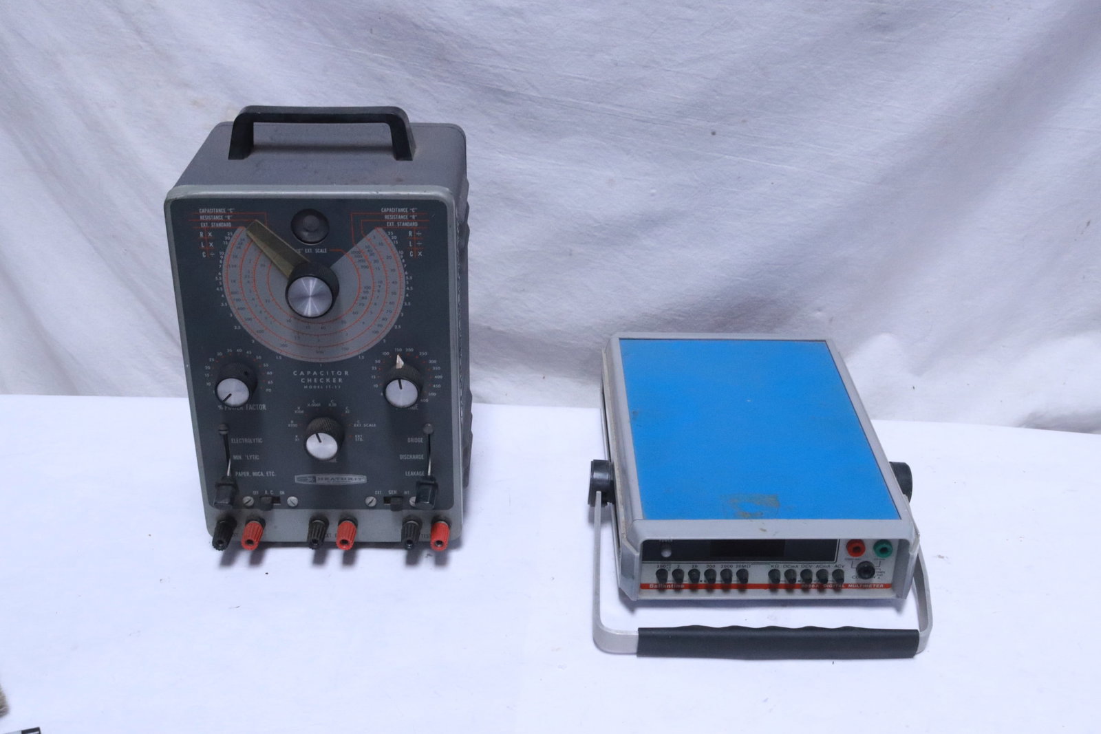 a capacity meter, and a digital multimeter: 2 electric meters; a capacity meter (12.5"x8.4"x2.85"), and a digital multimeter (11.2"x6.65"x6.2")