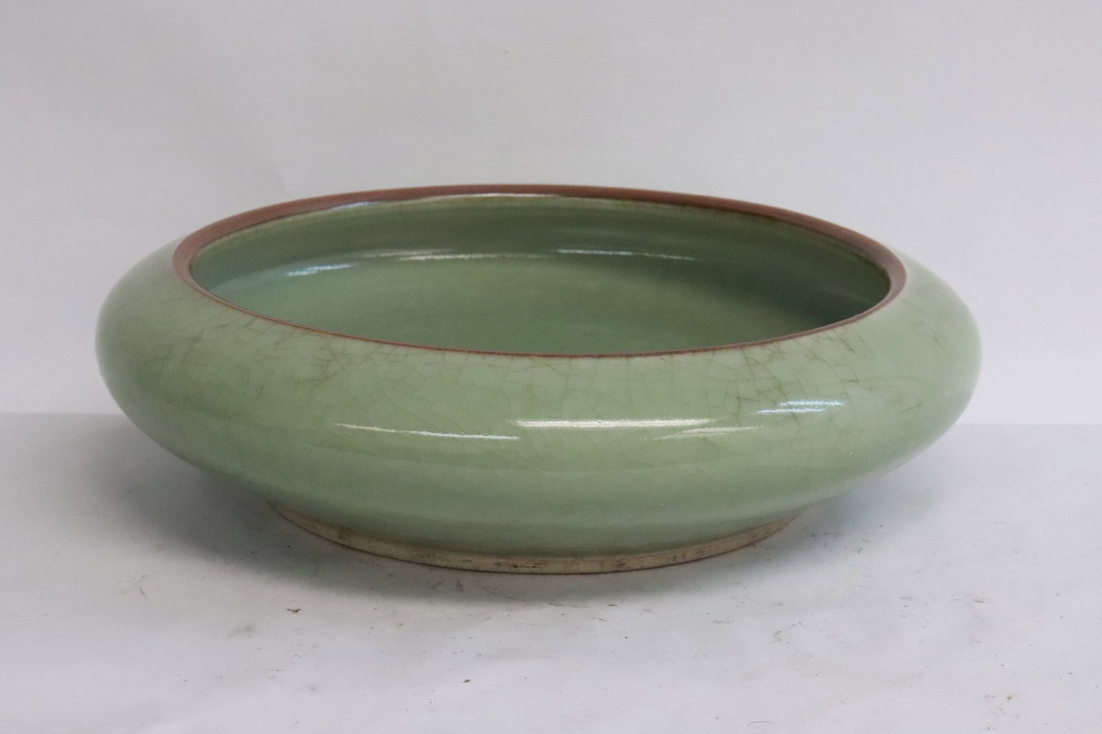 A celadon crackleware porcelain brush wash: A celadon crackleware porcelain brush wash, 2.75"x10.25"dia