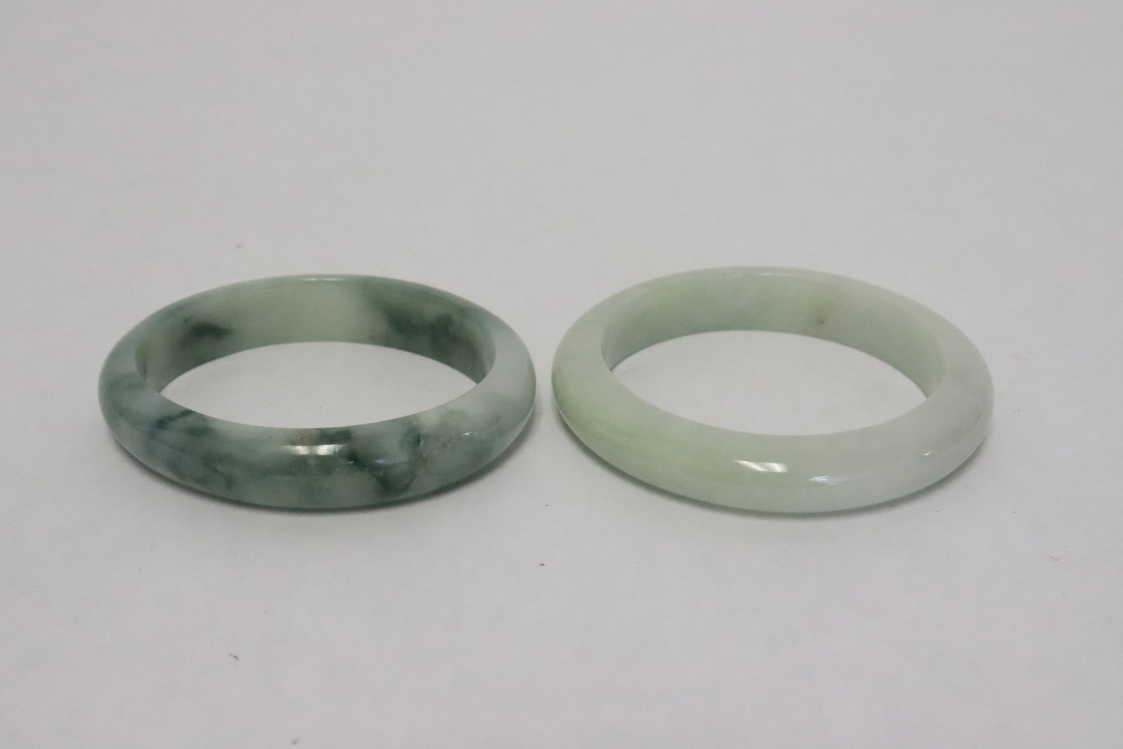 2 Chinese jadeite carved bangles: 2 Chinese jadeite carved bangles, 0.45"x2.35"x2.65", 0.4"x2.7"dia