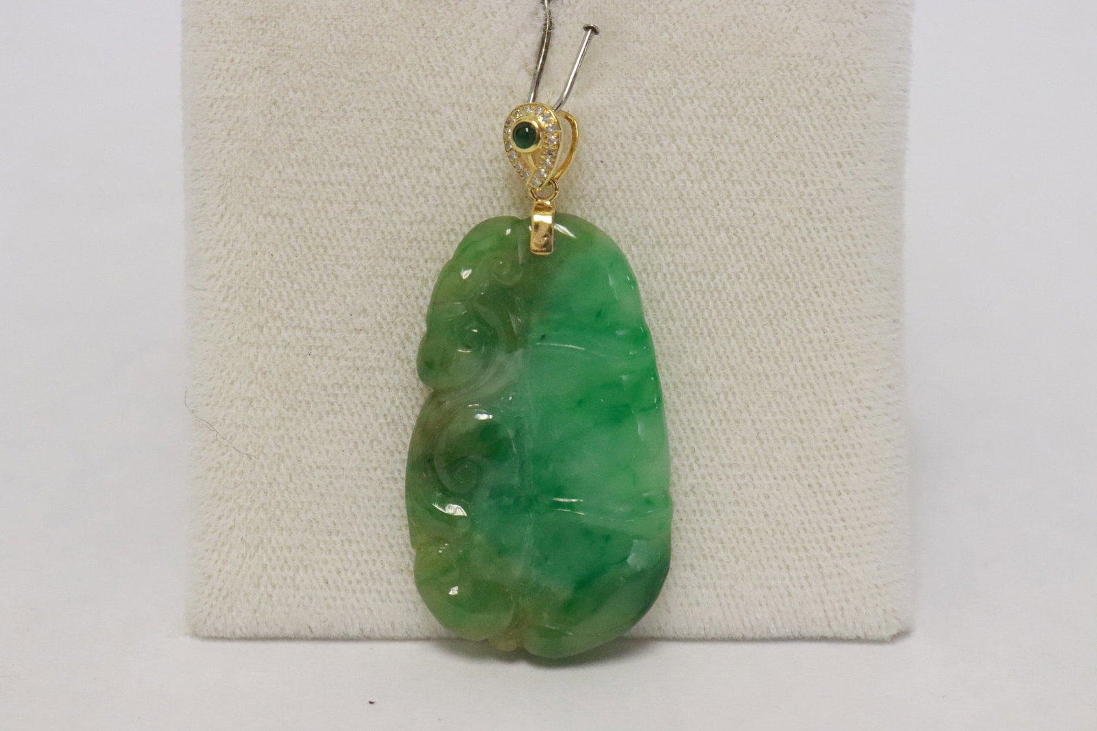 Chinese 19th/20th c. jadeite carved pendant: Fine Chinese 19th/20th century apple green jadeite carved pendant (1.5"x0.85"x0.18") with 18K Y/G bale