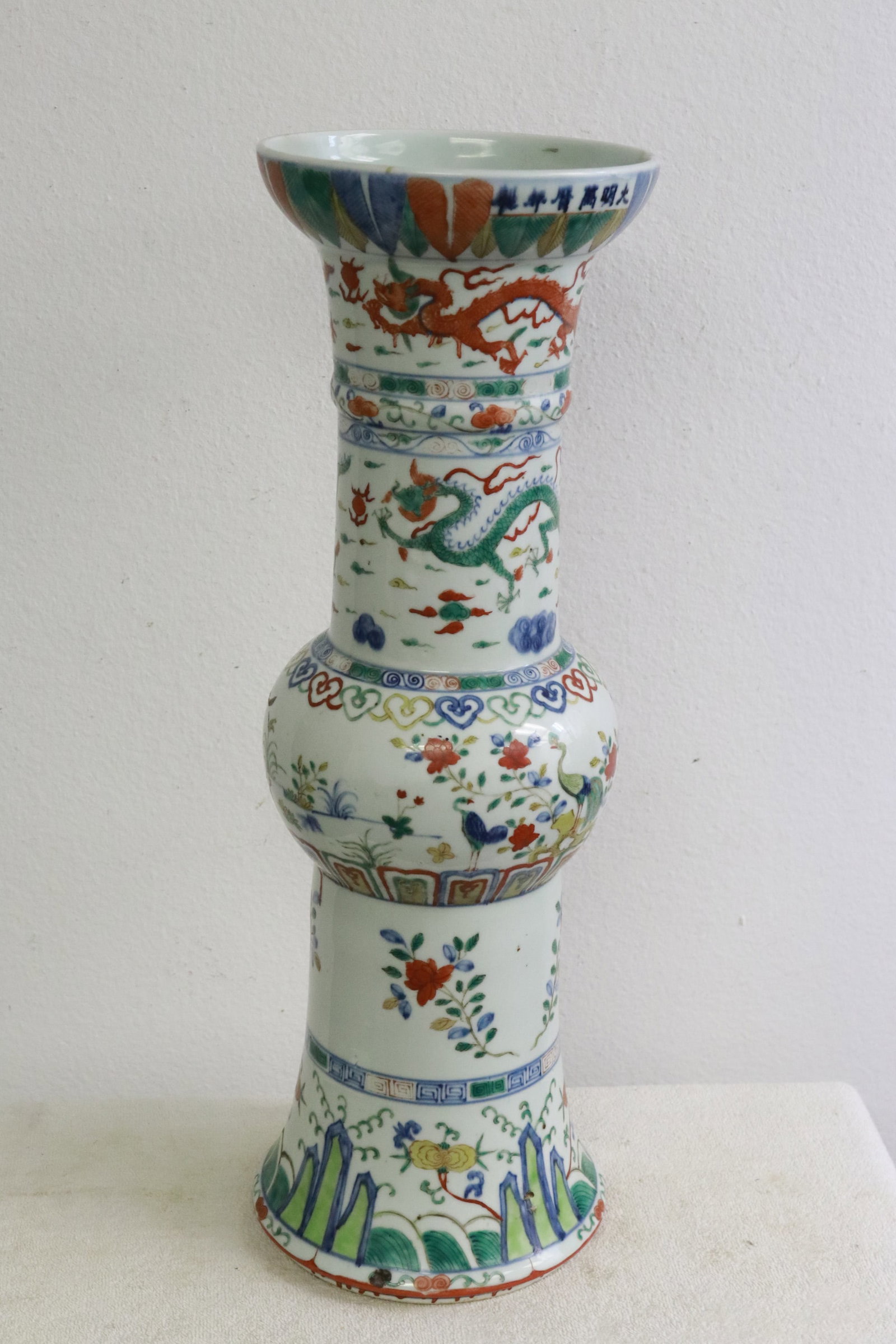 18th c. doucai porcelain gu vase, Yongzheng period: An important 18th century doucai porcelain gu vase painted with dragon motif decoration, Yongzheng period, hairline, 23.3"x7.65"dia