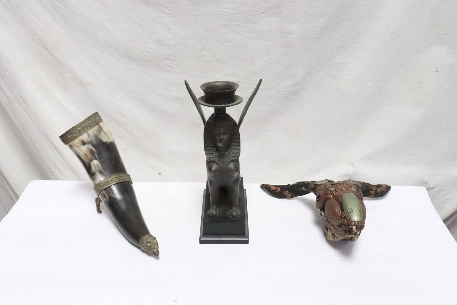 3 pieces: 3 pieces; bronze candle holder in Egyptian motif (11.85"H). a ram head motif table article (13"L), and a canoecopia (12"L)