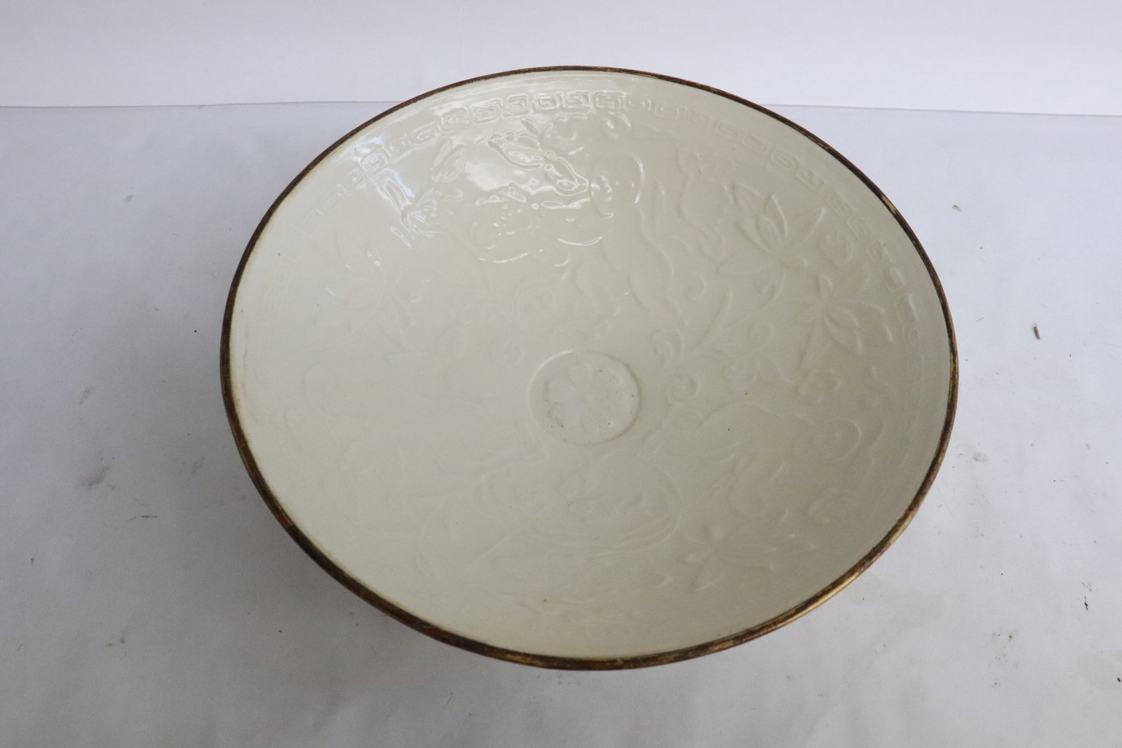 A white porcelain bowl with embossed decoration: A white porcelain bowl with embossed decoration, 2.45"x8"dia