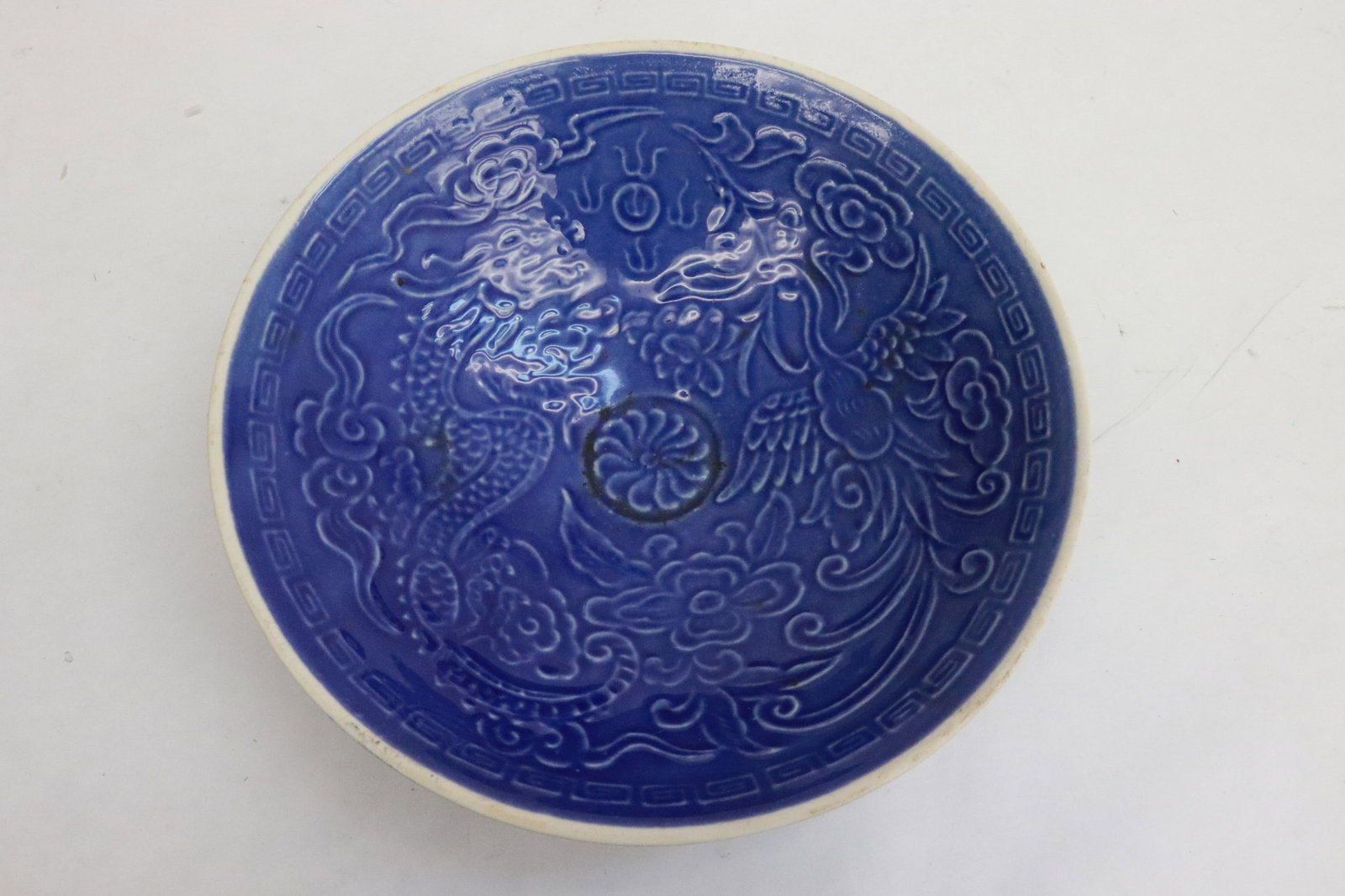 A blue glazed porcelain bowl: A blue glazed porcelain bowl with embossed decoration, 2.35"x8"dia