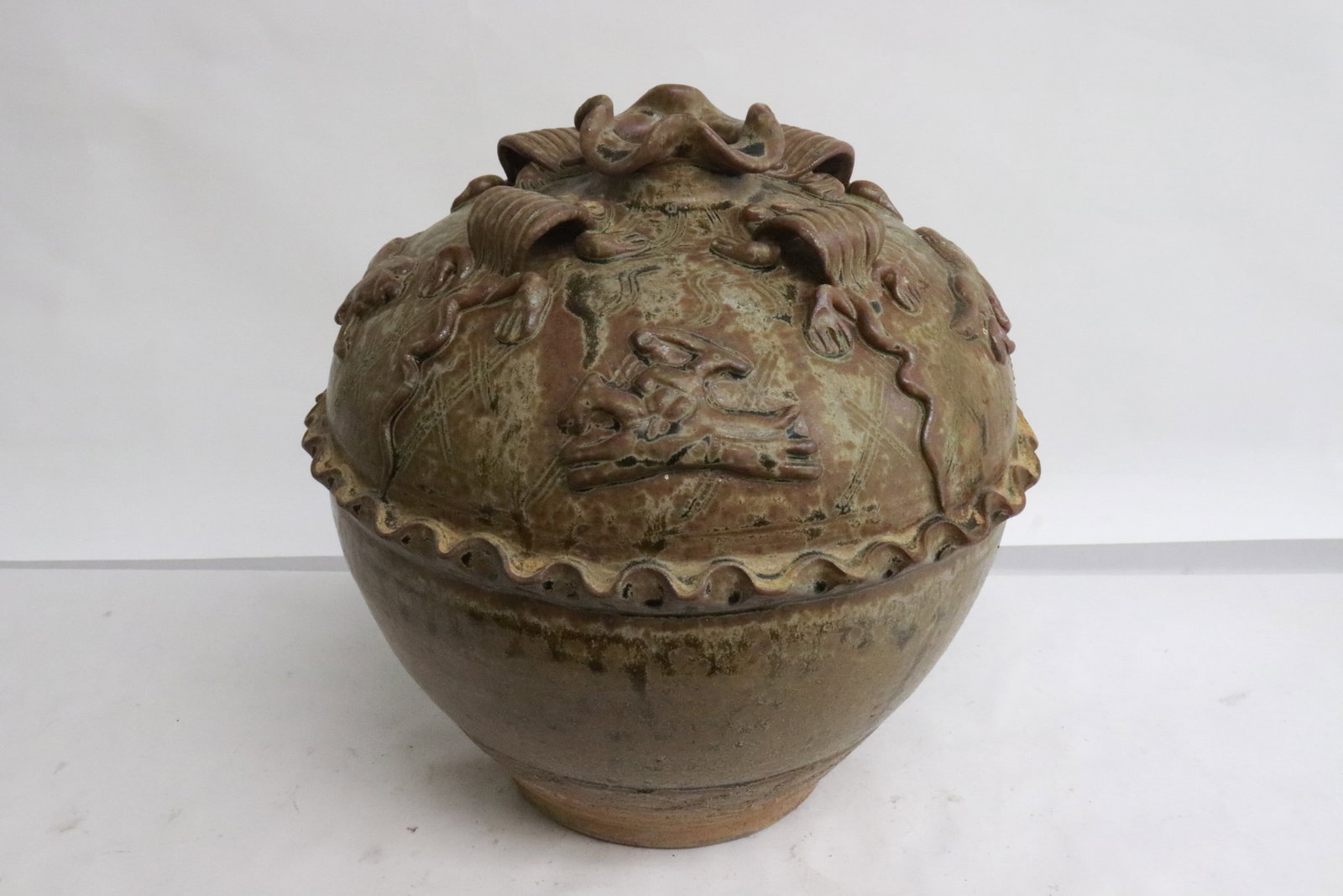 brown glazed earthenware round jar: Unusual brown glazed earthenware round jar with decoration in relief, 9.1"x9.15"dia