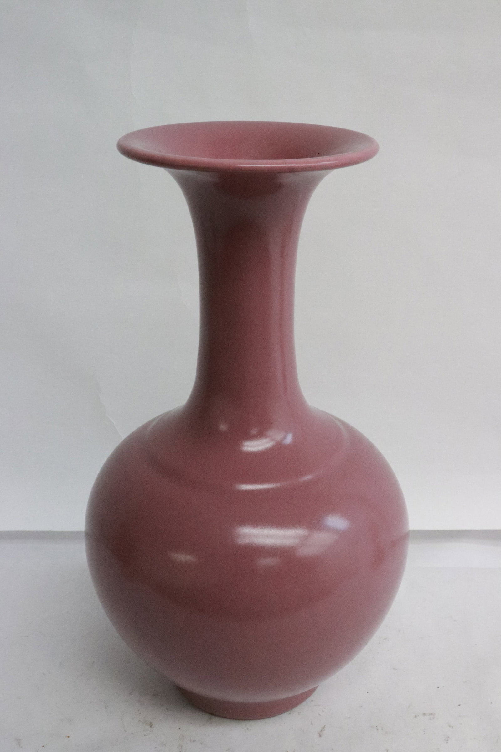 A pink glazed porcelain vase: A pink glazed porcelain vase, 9.4"x5.4"dia