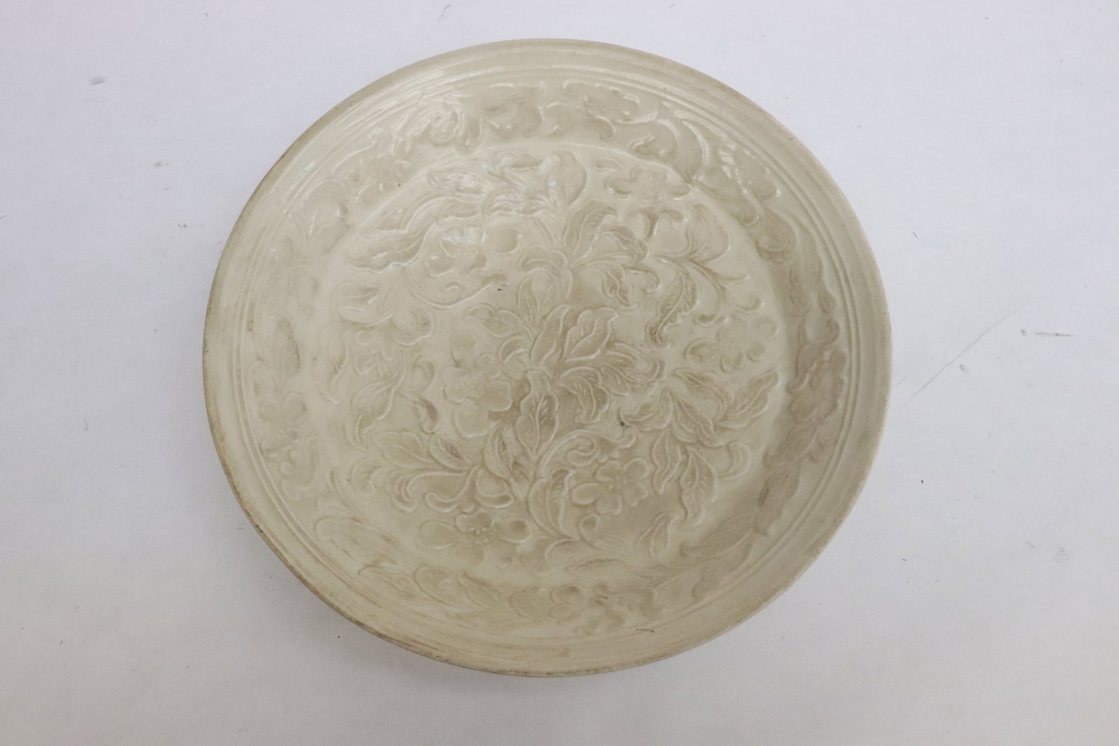 A Song style white porcelain bowl: A Song style white porcelain bowl with embossed decoration, 1.7"x8.15"dia