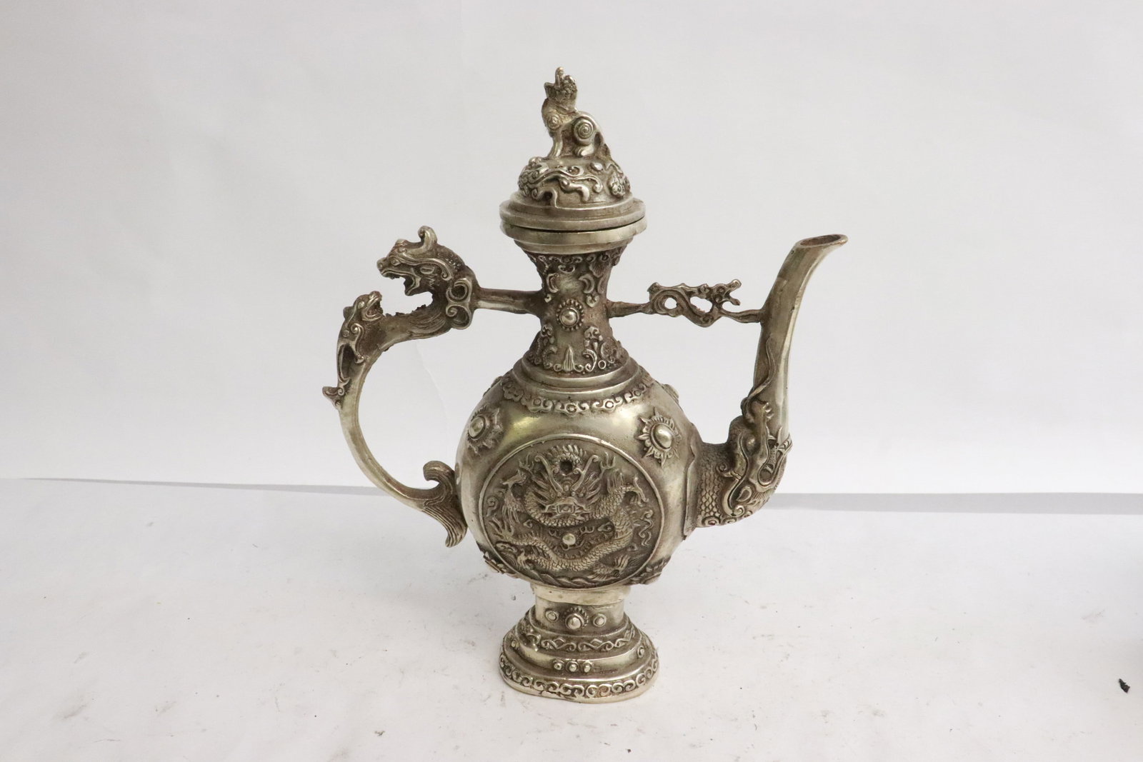 A white bronze wine server: A white bronze wine server, 8.75"x6.7"x2.5"