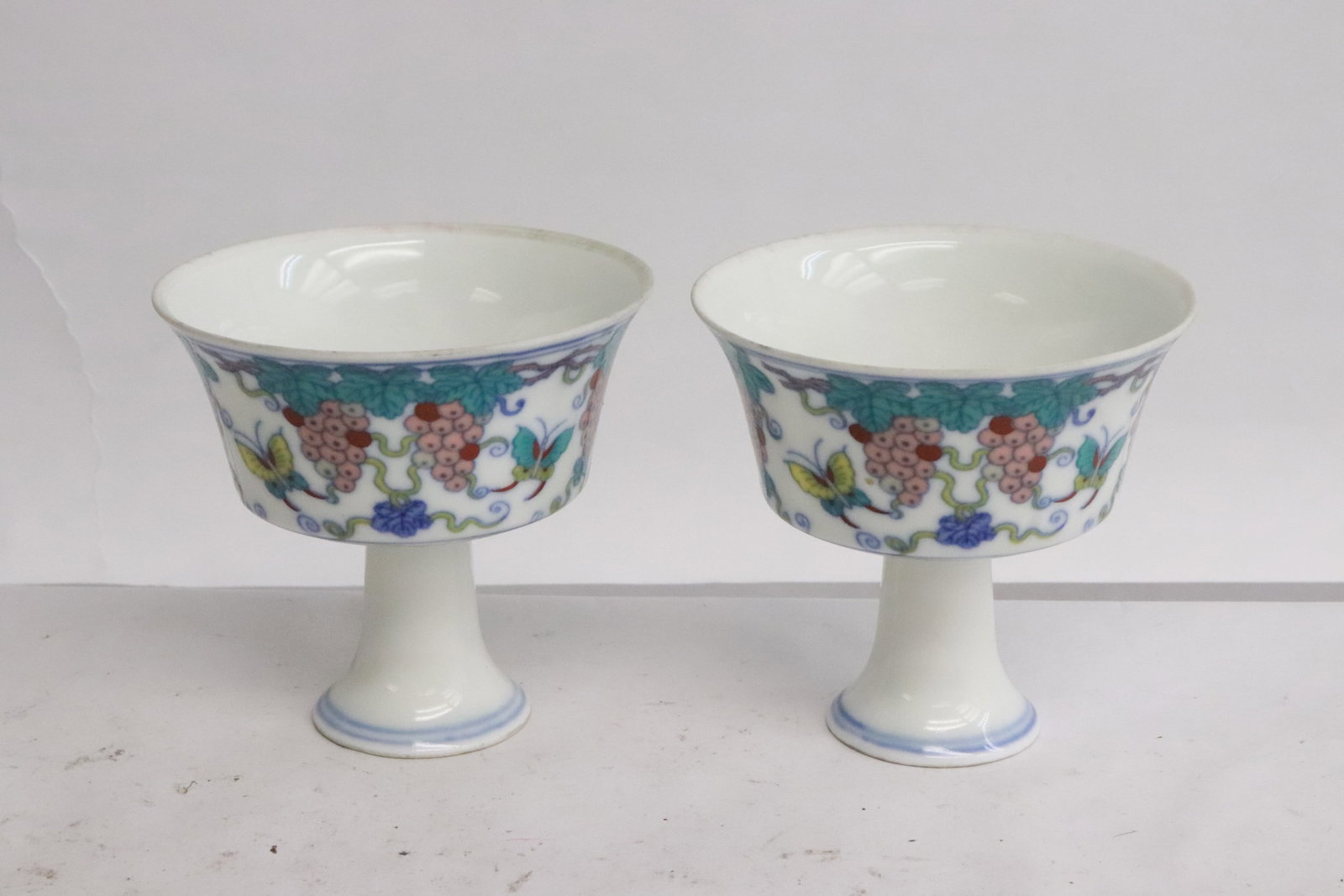 Pair fine wucai porcelain stem cups: Pair fine wucai porcelain stem cups, 3.1"x3.25"dia ea
