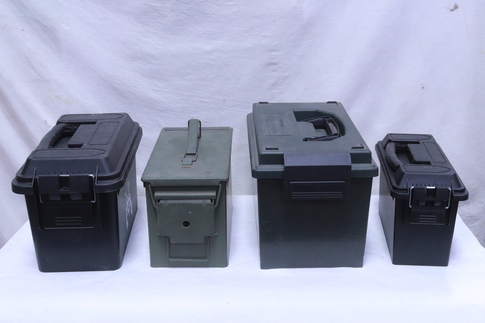 4 bullet storage cases; one metal, 3 hard plastic: 4 bullet storage cases (7.35"x11.4"x5.35" - 9.2"x15.7"x8.8"); one metal, 3 hard plastic