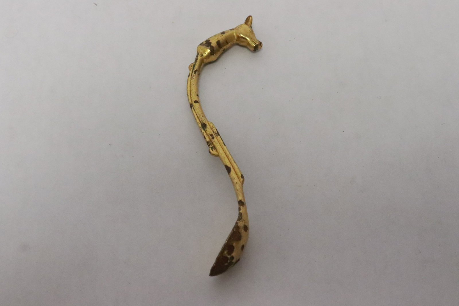 A possible Ming gilt metal spoon: A possible Ming gilt metal spoon with horse motif finial, 3.65"L